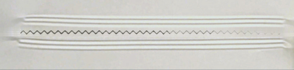 Carbon impression showing uneven cut from zig zag knife on flow wrapper